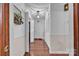 Hallway featuring hardwood floors, neutral paint, and white doors at 137 Proust Rd, Statesville, NC 28625