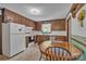Eat-in kitchen featuring wooden cabinets and a bright window over the sink at 137 Proust Rd, Statesville, NC 28625