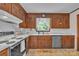 Traditional kitchen features wood cabinets, white countertops, and stainless steel appliances at 137 Proust Rd, Statesville, NC 28625