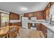Eat-in kitchen featuring wooden cabinets and a bright window over the sink at 137 Proust Rd, Statesville, NC 28625