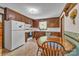 Eat-in kitchen featuring wooden cabinets and a bright window over the sink at 137 Proust Rd, Statesville, NC 28625
