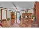 Bright living room featuring a brick fireplace and sliding glass doors to the backyard at 137 Proust Rd, Statesville, NC 28625