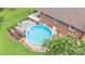 Aerial view of a backyard pool with a deck, patio, and well-maintained lawn at 137 Proust Rd, Statesville, NC 28625