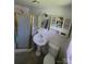 Bright bathroom with a pedestal sink, toilet, and glass-enclosed shower stall at 1512 Thompson Ave, Charlotte, NC 28216
