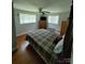 Spacious bedroom featuring hardwood floors, neutral walls, and comfortable bed setup at 1512 Thompson Ave, Charlotte, NC 28216