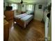 Bright bedroom with hardwood floors, light walls, and ample natural light at 1512 Thompson Ave, Charlotte, NC 28216