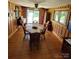 Cozy dining room featuring wood paneled walls and table at 1512 Thompson Ave, Charlotte, NC 28216