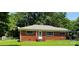 Charming brick home featuring a well-manicured lawn and inviting front entrance at 1512 Thompson Ave, Charlotte, NC 28216