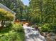 Beautiful landscaped backyard with a concrete path leading to an outdoor deck with seating at 1711 Apple Tree Ln # 28, Fort Mill, SC 29715