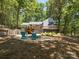 Backyard with a spacious wooden deck and a fire pit area with two blue Adirondack chairs at 1711 Apple Tree Ln # 28, Fort Mill, SC 29715