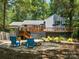 Backyard featuring a spacious deck and a fire pit area with blue Adirondack chairs at 1711 Apple Tree Ln # 28, Fort Mill, SC 29715