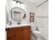 Well-lit bathroom with a wood vanity, round mirror, and tub-shower combo with white tiling at 1711 Apple Tree Ln # 28, Fort Mill, SC 29715