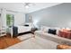 Bright bedroom with two beds, hardwood floors, a ceiling fan and blue accent wall at 1711 Apple Tree Ln # 28, Fort Mill, SC 29715