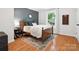 A serene bedroom featuring hardwood floors, a stylish rug, and a cozy bed with plush pillows at 1711 Apple Tree Ln # 28, Fort Mill, SC 29715