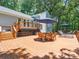 Expansive wooden deck featuring an outdoor dining area and lounge chairs with umbrellas, surrounded by lush trees at 1711 Apple Tree Ln # 28, Fort Mill, SC 29715