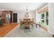 Dining room features a wooden table, chandelier, large window, and access to a modern kitchen at 1711 Apple Tree Ln # 28, Fort Mill, SC 29715
