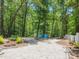 Fire pit area with two blue Adirondack chairs surrounded by trees and gravel at 1711 Apple Tree Ln # 28, Fort Mill, SC 29715