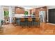 A modern kitchen with stainless steel appliances, wood cabinets, and a kitchen island with bar seating at 1711 Apple Tree Ln # 28, Fort Mill, SC 29715