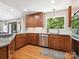 Modern kitchen features wood cabinets, stainless steel appliances, and a large window overlooking the yard at 1711 Apple Tree Ln # 28, Fort Mill, SC 29715