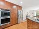 Bright kitchen features stainless steel appliances, wood cabinets, and a view into the adjacent dining area at 1711 Apple Tree Ln # 28, Fort Mill, SC 29715