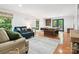 Spacious living room with hardwood floors, comfortable seating, and a billiards table at 1711 Apple Tree Ln # 28, Fort Mill, SC 29715