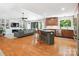 Bright open-concept living room with hardwood floors, built-ins, and a modern kitchen with stainless steel appliances at 1711 Apple Tree Ln # 28, Fort Mill, SC 29715