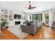Bright living room with hardwood floors, built-in shelves, a fireplace, and outdoor views at 1711 Apple Tree Ln # 28, Fort Mill, SC 29715