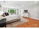 Bright main bedroom featuring hardwood floors, a seating area by the window, and a large dresser at 1711 Apple Tree Ln # 28, Fort Mill, SC 29715