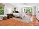 Spacious main bedroom with hardwood floors, a large window, and a comfortable seating area at 1711 Apple Tree Ln # 28, Fort Mill, SC 29715