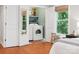Bedroom features in-suite laundry closet and window with view of the lush surrounding greenery at 1711 Apple Tree Ln # 28, Fort Mill, SC 29715