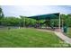 Community playground with covered play structure and mature trees at 18038 Greyfield Gln, Fort Mill, SC 29707