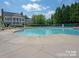 Community pool with large deck and ample seating adjacent to building at 18038 Greyfield Gln, Fort Mill, SC 29707