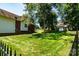 Expansive backyard featuring lush green lawn and mature trees, creating a serene and private outdoor space at 2124 Congress Ct, Kannapolis, NC 28083