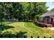 Fenced backyard with a well-maintained lawn, mature trees, and a wooden shed in the background at 2124 Congress Ct, Kannapolis, NC 28083