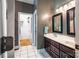 Bright bathroom featuring double sinks, framed mirrors, and a view into the walk-in closet at 2124 Congress Ct, Kannapolis, NC 28083