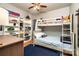 Cheerful bedroom featuring a bunk bed, hardwood floors, and built-in shelving filled with decorative objects at 2124 Congress Ct, Kannapolis, NC 28083