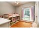 bedroom with a cute bunk bed, colorful curtains, and hardwood floors for a charming atmosphere at 2124 Congress Ct, Kannapolis, NC 28083