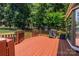 Wood deck area with grill and outdoor seating, mature landscaping, and a view of the backyard at 2124 Congress Ct, Kannapolis, NC 28083