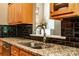 Kitchen countertop with stainless steel sink, granite countertops, and black backsplash tiles at 2124 Congress Ct, Kannapolis, NC 28083
