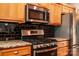 Stainless steel gas range, granite countertops and stainless steel microwave in a modern kitchen at 2124 Congress Ct, Kannapolis, NC 28083