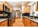 Modern kitchen with stainless steel appliances, granite countertops, hardwood floors, and dark backsplash at 2124 Congress Ct, Kannapolis, NC 28083
