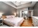 Spacious primary bedroom featuring hardwood floors, a large mirror, and a comfortable bed with pink bedding at 2124 Congress Ct, Kannapolis, NC 28083