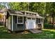 Close-up of a well-maintained outbuilding with windows and double doors, ideal for a workshop or storage area at 2124 Congress Ct, Kannapolis, NC 28083