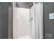 Clean shower stall with a white shower curtain offering a functional and simple design at 2124 Congress Ct, Kannapolis, NC 28083