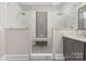 A luxurious glass walk-in shower showcases elegant tile work and a built-in bench for a spa-like experience at 229 N Church St # 100, Charlotte, NC 28202