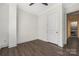 Bedroom with hardwood floors and neutral walls, featuring crown molding and two electrical outlets on the walls at 229 N Church St # 100, Charlotte, NC 28202