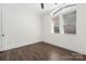 Empty bedroom with hardwood floors and a large window, creating a serene and peaceful space for rest at 229 N Church St # 100, Charlotte, NC 28202
