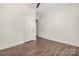 Bedroom with hardwood floors and neutral walls, showing crown molding and a view into another room at 229 N Church St # 100, Charlotte, NC 28202