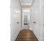 Hallway with wood floors leading to the bathroom, providing a sneak peek of a modern, stylish bathroom space at 229 N Church St # 100, Charlotte, NC 28202