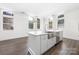 Kitchen with large island featuring a stainless steel farmhouse sink, dishwasher, and lots of room for seating at 229 N Church St # 100, Charlotte, NC 28202